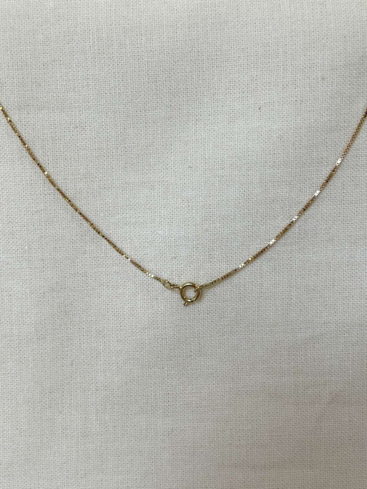 corrente veneziana 0,6mm ouro 18k em tecido de linho