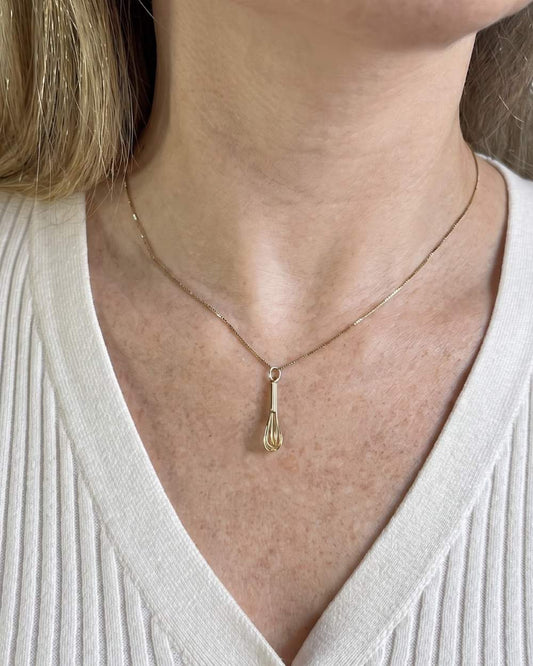 Mulher usando colar com pingente fouet em ouro 18k