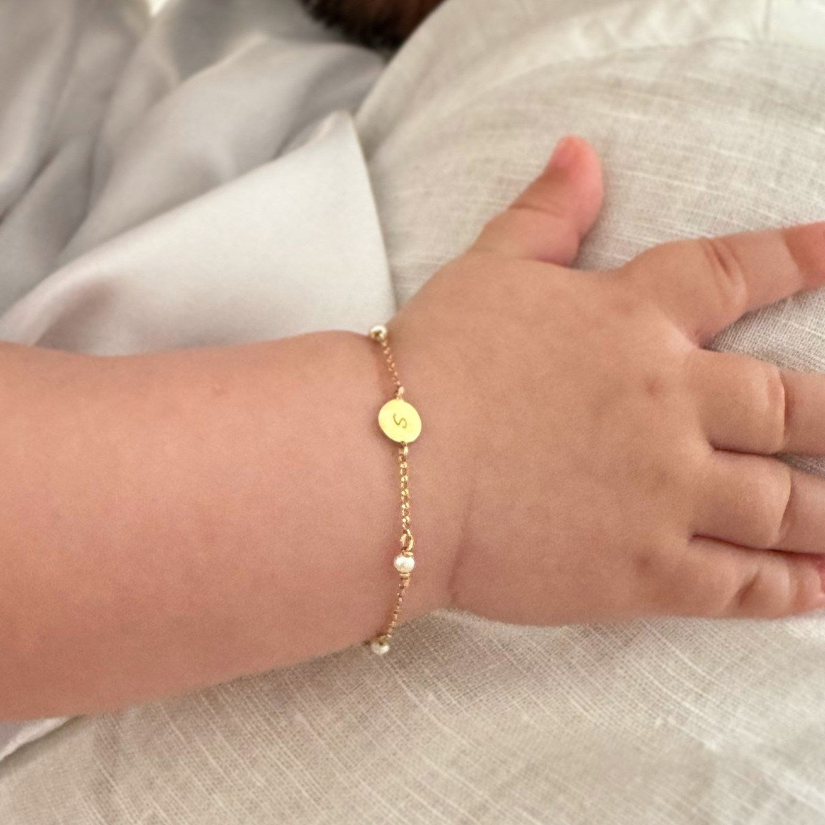 Pulseira bebe ouro 18k medalha letra perolas naturais no pulso do bebe